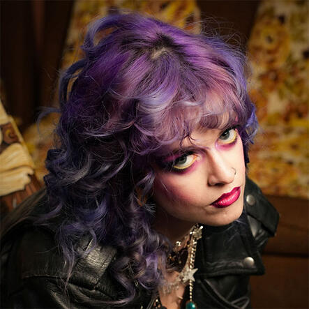 Model with vibrant purple styled hair
