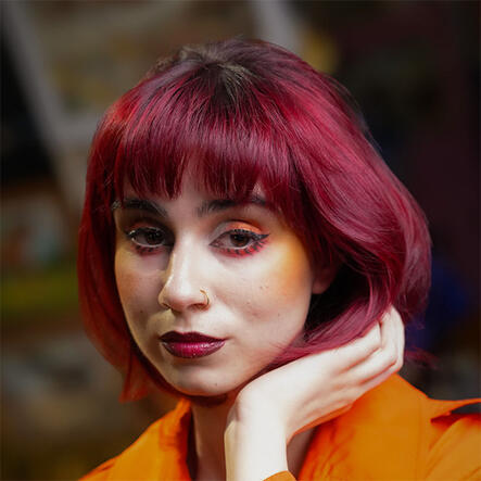 Model with styled burgundy bob cut